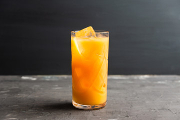 Fresh beverage with mandarines on the rustic background. Selective focus. Shallow depth of field. 
