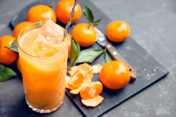 Fresh beverage with mandarines on the rustic background. Selective focus. Shallow depth of field.