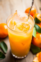 Fresh beverage with mandarines on the rustic background. Selective focus. Shallow depth of field.