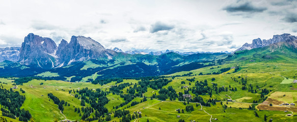 Alpe di Siusi, Seiser Alm with Sassolungo Langkofel Dolomite, lush green field in Seiser Alm...