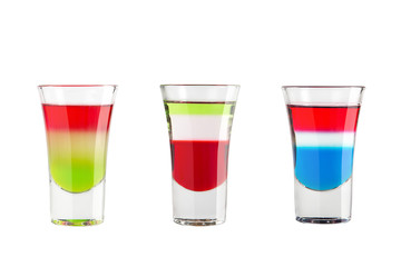 Alcohol shots on a white background. Three shots with bright colors.