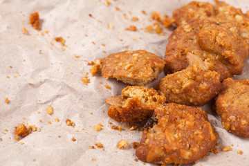 Cookie on crumpled brown paper with space.