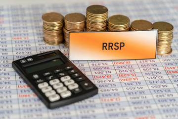 Stacks of coins on spreadsheet showing Growth in RRSP Savings