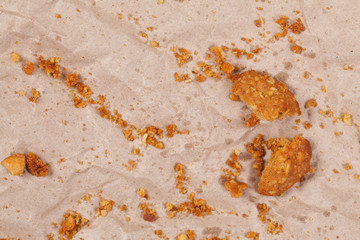 Cookie on crumpled brown paper with space.