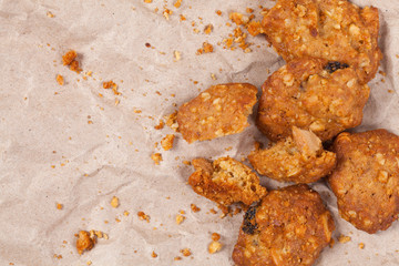 Cookie on crumpled brown paper with space.