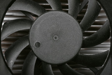 Black CPU fan on a radiator background. Macro photo from above.