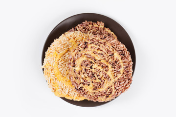 NangLet is a name of rice cake round and flat sweetmeat is a dessert in Thailand, Put on brown plate on white background isolated.