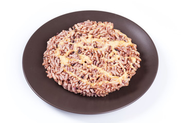 NangLet is a name of rice cake round and flat sweetmeat is a dessert in Thailand, Put on brown plate on white background isolated.