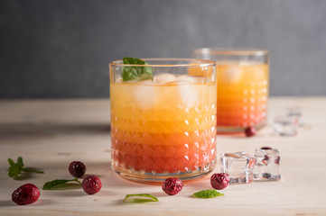 Exotic orange cocktails on light background