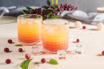 Exotic orange cocktails on light background