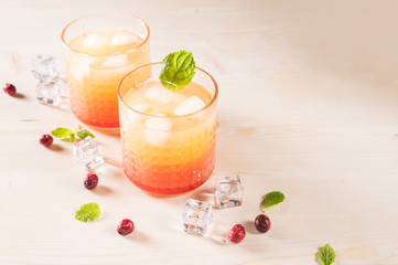 Exotic orange cocktails on light background