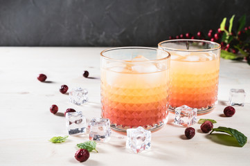 Exotic orange cocktails on light background