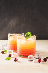 Exotic orange cocktails on light background