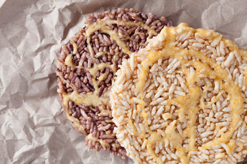 Nang Let is a name of rice cake round and flat sweetmeat is a dessert in Thailand, Put on crumpled brown paper background.