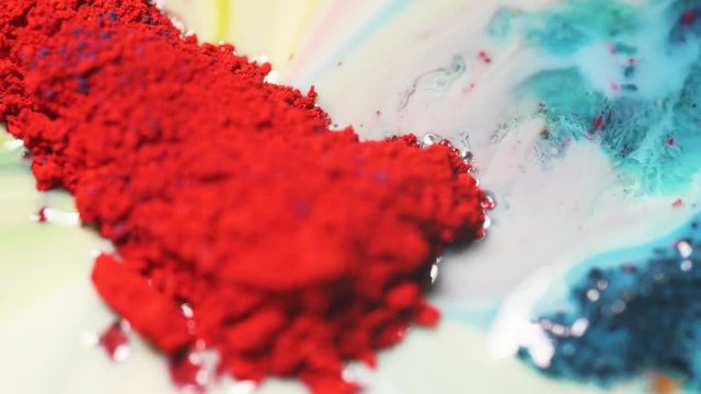 Close-up of colorful red pigment on a white liquid surface. Colorful concept.