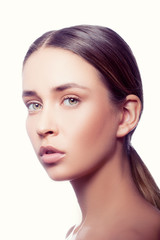 Fototapeta premium Beauty skin care portrait of young model girl. Natural nude make-up, hair style, green eyes. White background