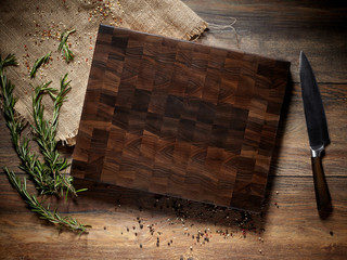 Top view of a beautiful dark cutting board with a knife