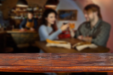 Mockup. Blurred bar in the background. A wooden board in the foreground.