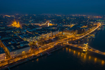 Budapest, Hungary - Aerial skyline view of Pest side of Budapest with illuminated Szechenyi Chain Bridge and St. Stephen's Basilica at blue hour