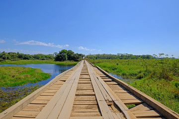 Old damaged wooden bridge on the transpantaneira dirt road with Pantanal wetland, Porto Jofre, Mato Grosso, Brazil