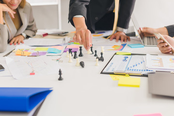 A group of Asian businessmen are discussing their work.All people share brainstorm ideas at work.