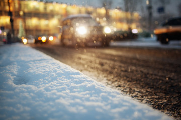car lights in winter snow city