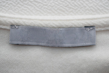 blank clothing label on white fabric texture background