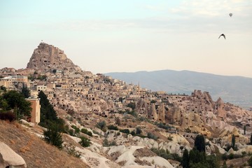 Fototapeta na wymiar View of ancient Nevsehir cave town and a castle of Uchisar dug from a mountains in Cappadocia, Central Anatolia,Turkey