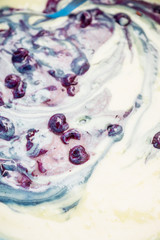 Muffins making. Raw dough mixing with berries. Selective focus.