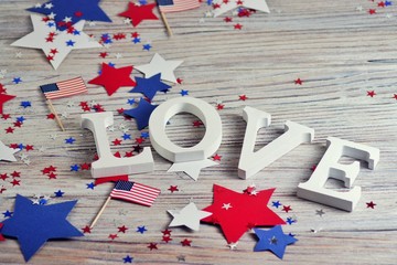 Wooden letters are laid out in the word love, July 4, happy independence day, patriotism, memory of veterans, the concept 