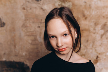 Cheerful beautiful close up portrait of young adorable teenage model posing in studio. Fashion kids,beauty, teenage girl concept