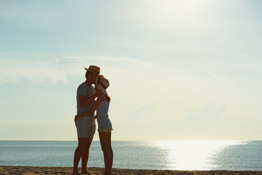 Couples are showing love and exercise. And taking pictures of pre-wedding At the beach with morning sunshine near the sea