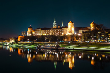 Fototapeta na wymiar The Royal Wawel Castle as seen from another bank of Vistula. Krakow is the most famous landmark in Poland. Night view