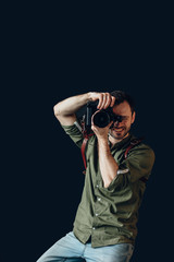 cheerful young talented photographer working at the studio, job, occupation concept