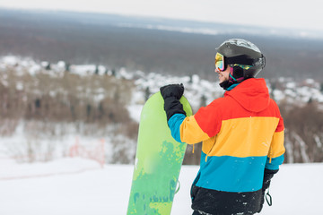 awesome snowboarder checking the slope, back view photo. copy space, brathtaking view from the top...
