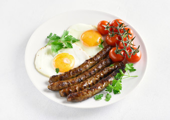 Fried eggs, sausages and cherry tomatoes
