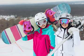 two pretty sisiters spending time on the moutain, close up photo. happiness, hobby, interest