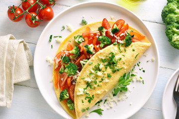 Stuffed omelet with tomatoes, red bell pepper and broccoli