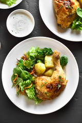 Grilled chicken leg with potato and green salad