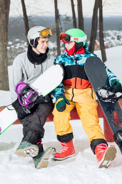 two loving amorous snowboarders resting on the top of the ski slope. close up photo. love, friendship, relationship, feeling, emotion concept