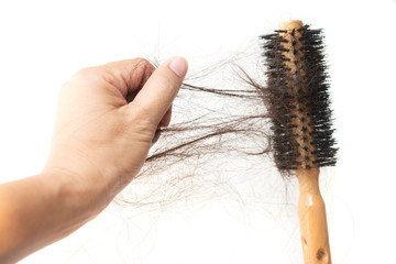 Hand grabbing lost hair on brush