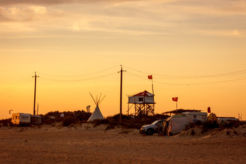 landscape creative home of aboriginal people on a wild vacation on the ocean with a wigwam and a tree house. the concept of free independent rebellious life in nature. sunset and toned © Fotony76