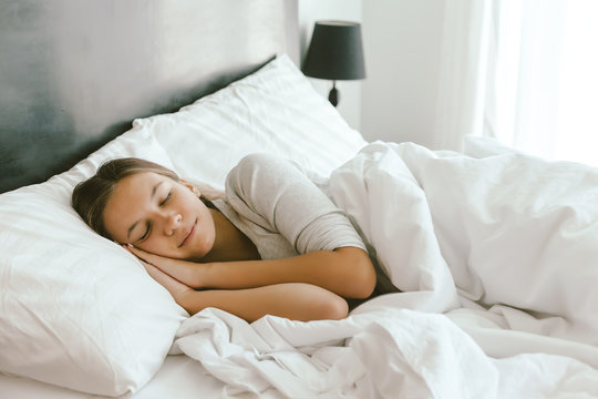 Girl sleeping in bed in hotel room