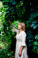 Portrait of beautiful blonde woman in summer garden.