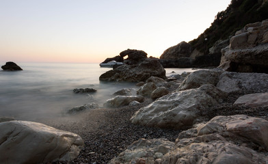 rocks in sea at sunset
