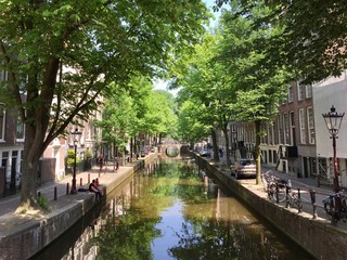 Fototapeta na wymiar A summer sunny day on a pretty Amsterdam canal in the Netherlands