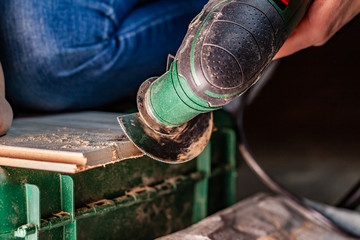 Close up of woman cutting laminate of wooden floor