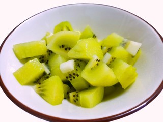 Top view of fresh sliced Kiwi fruit on white bowl isolated on white background, for making drinks or salads, healthy food concept