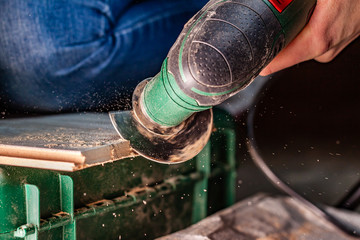 Close up of woman cutting laminate of wooden floor