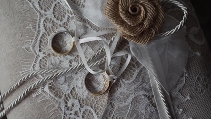 Wedding rings on a white cushion